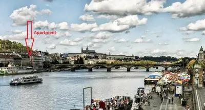 a view of a river with a bridge and a city at Urban, 2 Bedroom, six min tram Charles bridge in Prague