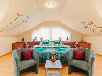 a bedroom with a bed and two chairs at Villa Garden & Terrace Villa by Interhome in Prague