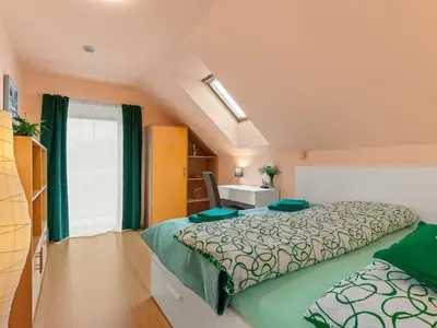 a bedroom with a bed and a desk and a window at Villa Garden & Terrace Villa by Interhome in Prague