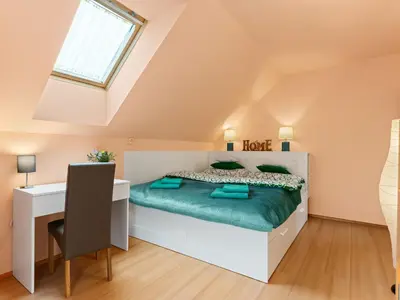 a bedroom with a bed and a desk and a window at Villa Garden & Terrace Villa by Interhome in Prague