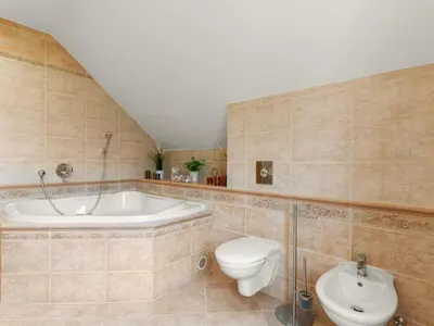 a bathroom with a tub and a toilet and a sink at Villa Garden & Terrace Villa by Interhome in Prague