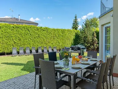 a dining table and chairs on a patio at Villa Garden & Terrace Villa by Interhome in Prague