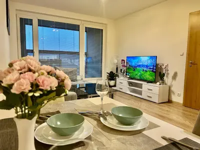 a living room with a tv and a couch and a table at Tomaš Apartment,Free Parking-02 Arena in Prague