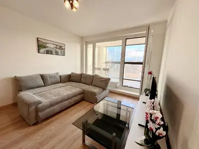a living room with a table with a vase of flowers at Tomaš Apartment,Free Parking-02 Arena in Prague