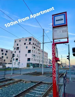 a sign on a pole next to train tracks at Tomaš Apartment,Free Parking-02 Arena in Prague
