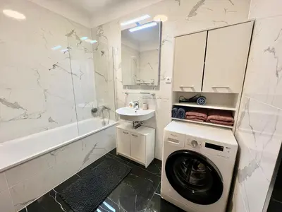 a white bathroom with a washing machine and a sink at Tomaš Apartment,Free Parking-02 Arena in Prague