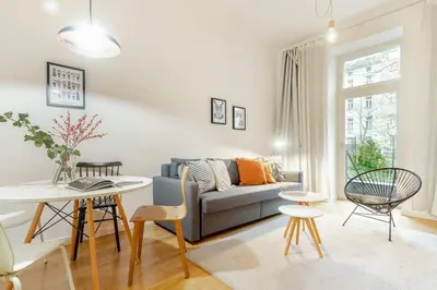 a living room with a couch and a table at Modern apartment with garden in Prague
