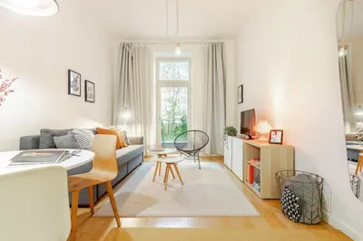 a living room with a couch and a table at Modern apartment with garden in Prague