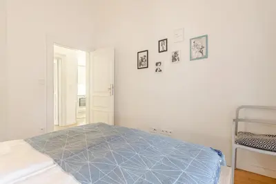 a bedroom with a bed with a blue comforter at Modern apartment with garden in Prague