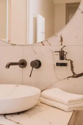 a bathroom with a sink and a mirror at Luxury Design Apartment at Old Town Square with Air Condition in Prague