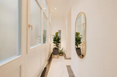 a hallway with a mirror and potted plants at Luxury Design Apartment at Old Town Square with Air Condition in Prague
