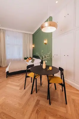 a living room with a table and a bed at Luxury Design Apartment at Old Town Square with Air Condition in Prague