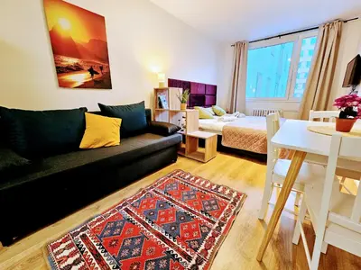a living room with a couch and a bed at TERRACE-VIEW PRAGUE APARTMENTS for Business & Leisure, FREE PARKING & Gym, Near Metro & Aqua Sport Centre in Prague