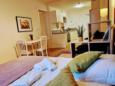 a bedroom with a bed with towels on it at TERRACE-VIEW PRAGUE APARTMENTS for Business & Leisure, FREE PARKING & Gym, Near Metro & Aqua Sport Centre in Prague