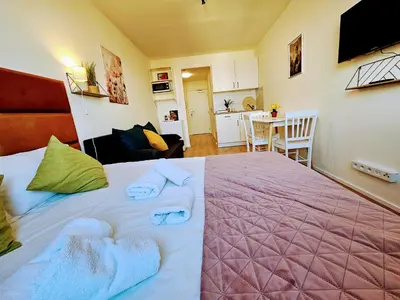 a bedroom with a large bed with towels on it at TERRACE-VIEW PRAGUE APARTMENTS for Business & Leisure, FREE PARKING & Gym, Near Metro & Aqua Sport Centre in Prague