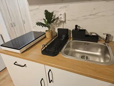 a kitchen counter with a sink and a keyboard at LIVE-INN PRAGUE SUPERIOR SUITE FOR 1-4 GUESTS, 20 Mins to center, Lift, Gym, Reception, Parking, Roof Terrace, Game & Party Room in Prague