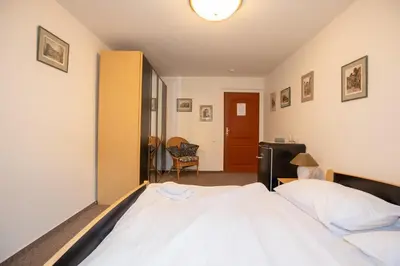 a bedroom with a large white bed in it at Resort U Jelena in Křivoklát