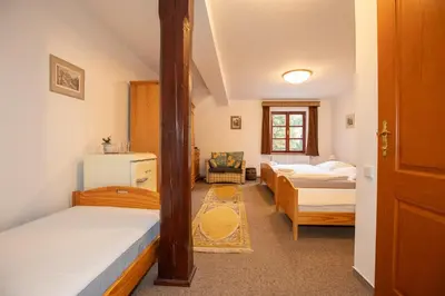 a small room with two beds and a room with a bed sqor at Resort U Jelena in Křivoklát