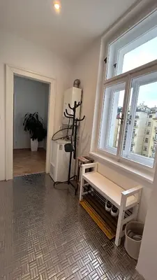 a room with a window with a bench and a table at Stylish accommodation in the center of Prague in Prague