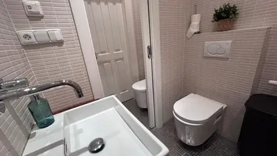 a white bathroom with a toilet and a sink at Stylish accommodation in the center of Prague in Prague