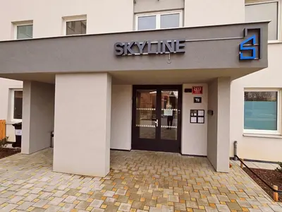 a building with a sign that reads skyline at TERRACE-VIEW 2BR PRAGUE APARTMENTS for Business & Leisure, FREE PARKING & Gym, Near Metro & Aqua Sport Centre in Prague