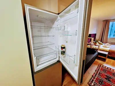 an empty refrigerator with its door open in a room at TERRACE-VIEW 2BR PRAGUE APARTMENTS for Business & Leisure, FREE PARKING & Gym, Near Metro & Aqua Sport Centre in Prague