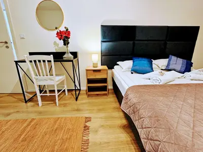 a bedroom with a bed and a desk and a chair at TERRACE-VIEW 2BR PRAGUE APARTMENTS for Business & Leisure, FREE PARKING & Gym, Near Metro & Aqua Sport Centre in Prague