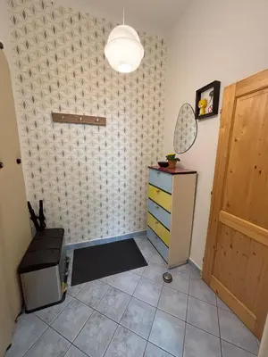 a room with a dresser and a cabinet and a door at Vintage Brussels Style on Prague 4 in Prague