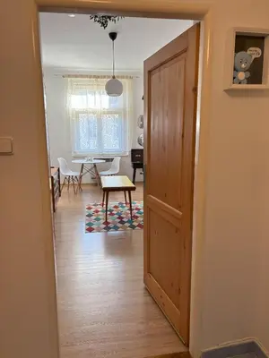 a hallway with a door leading to a living room at Vintage Brussels Style on Prague 4 in Prague