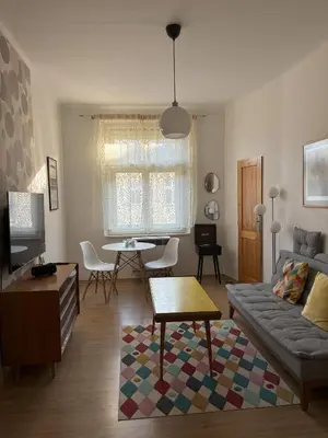 a living room with a couch and a table at Vintage Brussels Style on Prague 4 in Prague
