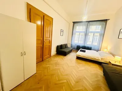 a room with a bed and a couch and a window at Retro style in centrum Prague Andel in Prague