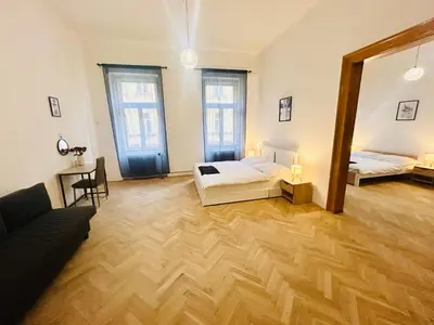 a large room with two beds and a mirror at Retro style in centrum Prague Andel in Prague