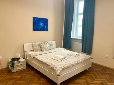 a bedroom with a bed with two towels on it at Spacious 4BR Apartment by Charles Bridge in Prague