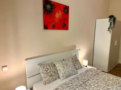 a bedroom with a bed and a painting on the wall at Spacious 4BR Apartment by Charles Bridge in Prague