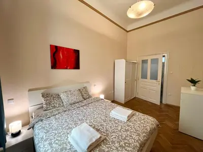 a bedroom with a bed and a painting on the wall at Spacious 4BR Apartment by Charles Bridge in Prague