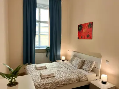a bedroom with a bed and a window at Spacious 4BR Apartment by Charles Bridge in Prague