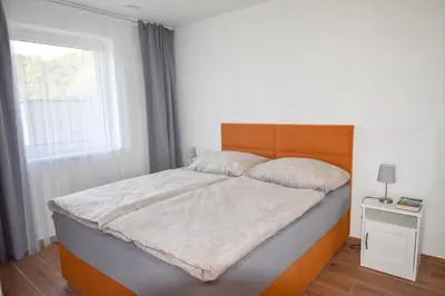 a large bed in a bedroom with a window at Chata U Bezedné in Velký Osek