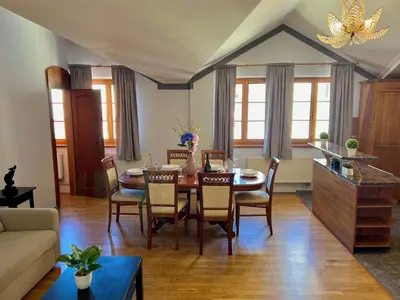 a living room with a dining room table and chairs at Comfortable 3 Bedroom apartment in the Heart of Prague in Prague
