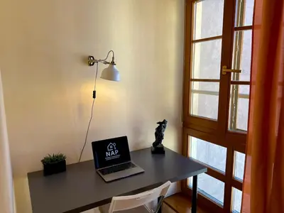 a desk with a laptop computer on top of it at Comfortable 3 Bedroom apartment in the Heart of Prague in Prague