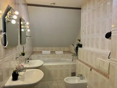 a bathroom with two sinks and a bath tub at Comfortable 3 Bedroom apartment in the Heart of Prague in Prague