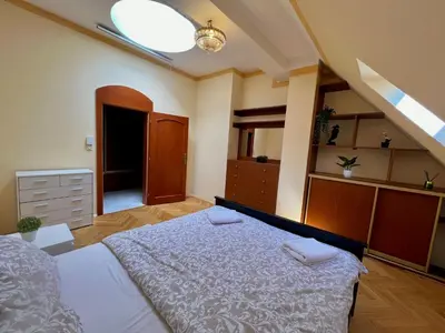 a bedroom with a bed and a dresser at Comfortable 3 Bedroom apartment in the Heart of Prague in Prague