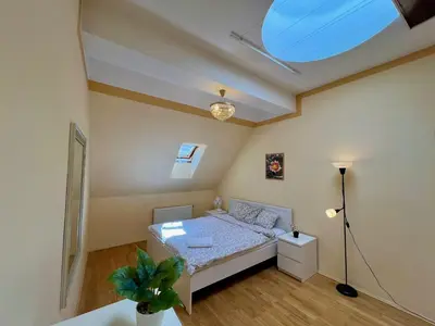 a bedroom with a white bed in a room at Comfortable 3 Bedroom apartment in the Heart of Prague in Prague