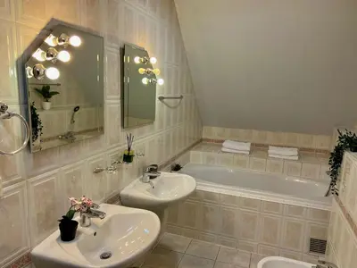 a bathroom with a sink and a tub and a toilet at Comfortable 3 Bedroom apartment in the Heart of Prague in Prague