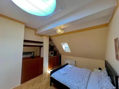 a bedroom with a bed and a ceiling at Comfortable 3 Bedroom apartment in the Heart of Prague in Prague