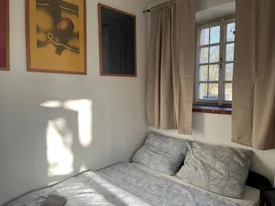 a bedroom with a bed and a window at Nostalgická myš in Kokořín