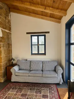 a living room with a couch and a window at Nostalgická myš in Kokořín