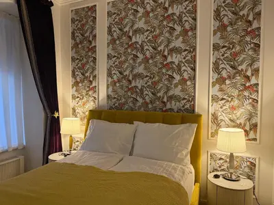 a bedroom with a bed and two tables with lamps at Momoko in Prague