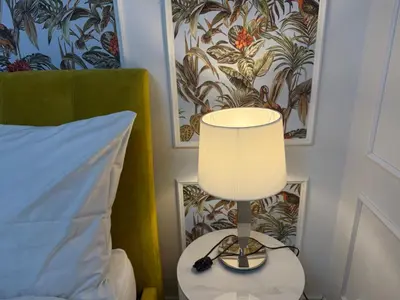 a lamp sitting on a table next to a bed at Momoko in Prague