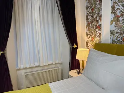 a bedroom with a bed and a window at Momoko in Prague