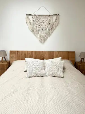 a bedroom with a white bed with two lamps at Charming studio near Prague Airport in Tuchoměřice